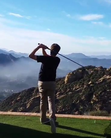 Junior Elias Gross takes a swing at competitive golf